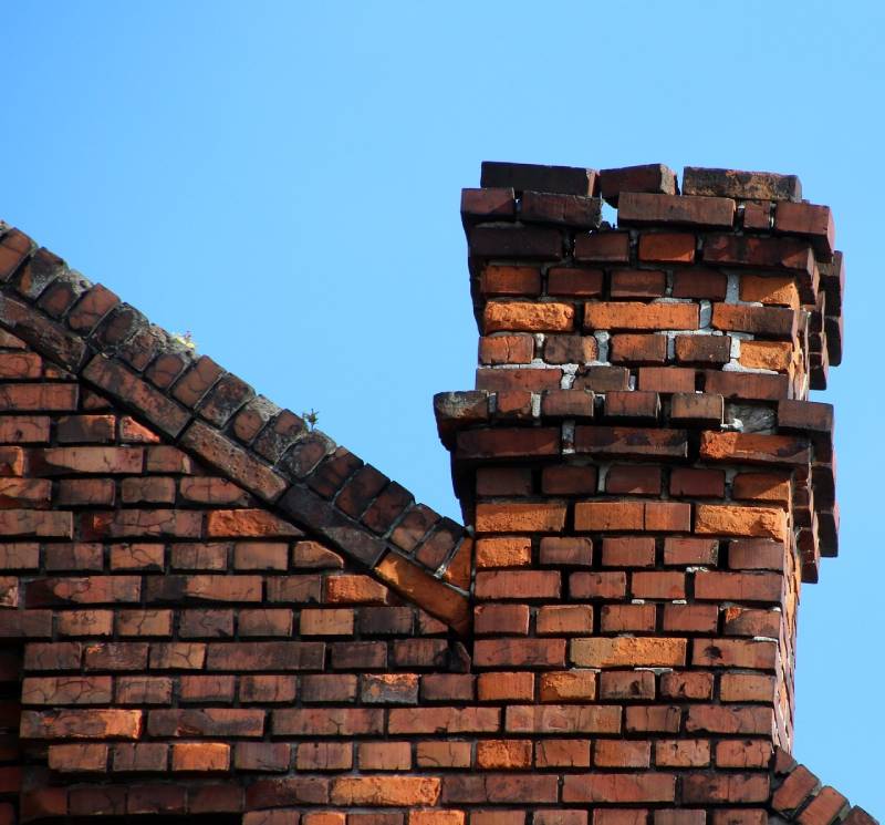Damaged chimney on an Pembroke Pine home showing cracks and missing mortar